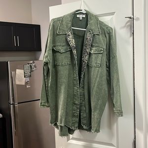 Green with reptile print collar and button down shacket. She and sky. Medium